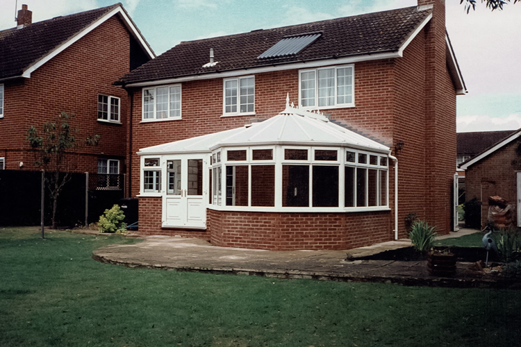 White PVCu Victorian P Shape Combination Dwarf wall Conservatory with 25mm clear polycarbonate roof sheets & French doors