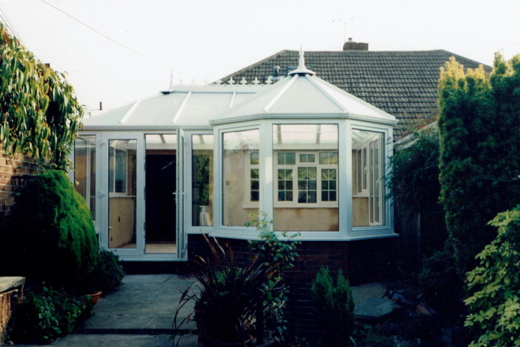White PVCu Victorian P Shape Combination Dwarf wall Conservatory with 25mm Opal polycarbonate roof sheets & Tilt/Turn windows, French doors