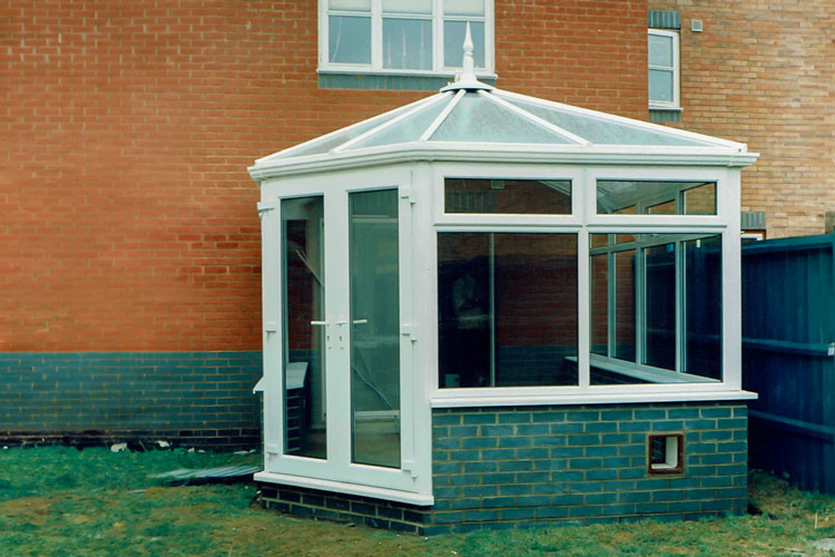 Edwardian Conservatory with one 135 degree corner, French doors & polycarbonate roof sheets.