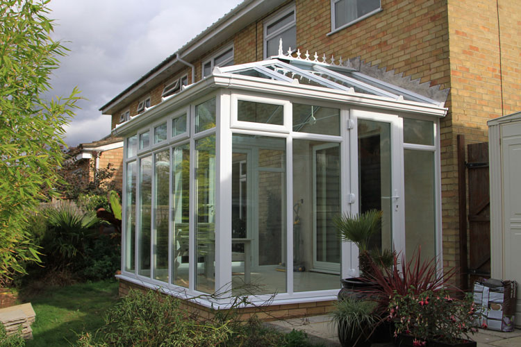 Edwardian Conservatory Glass to Floor style, Sloar control self cleaning Glass roof. Fanlight opening windows & single door.