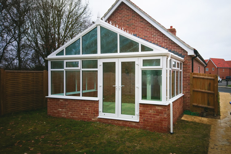 White PVCu Georgian Gable Conservatory with Solar control self cleaning roof & white PVCu French doors 