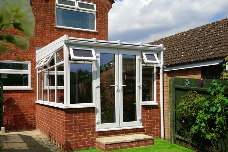 White PVCu Lean-To Conervatory with 35mm Heat Guard Polycarbonate roof sheets, French doors & 600mm dwarf wall