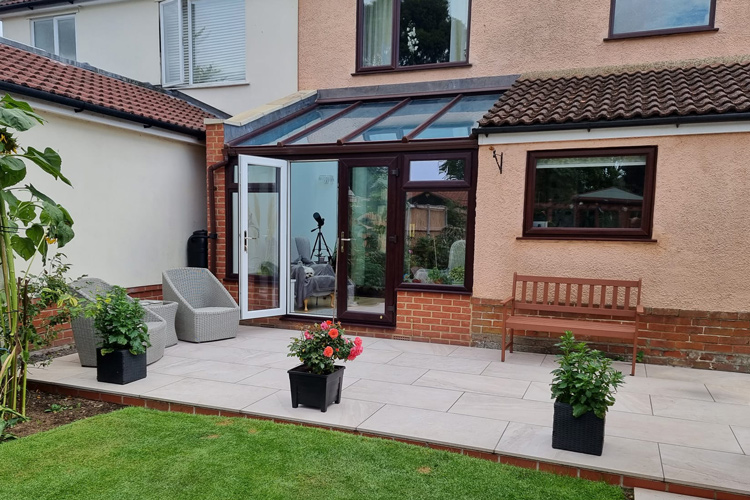Rose wood PVCu Lean-To Conervatory with solar control glass roof sheets, French doors & 600mm dwarf wall